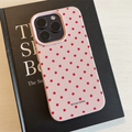 Pink polka dot phone case flat lay